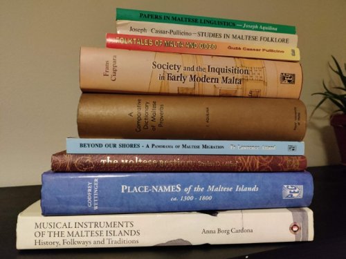 A pile of books about Maltese folklore, history, and culture